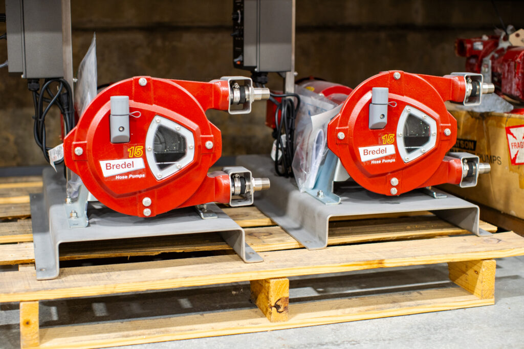Two bright red Bredel Hose pumps.